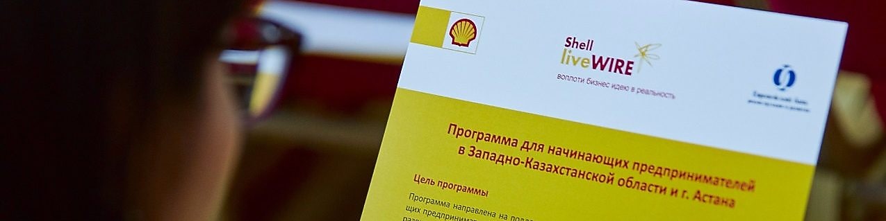Участник тренинга смотрит брошюру Shell LiveWIRE